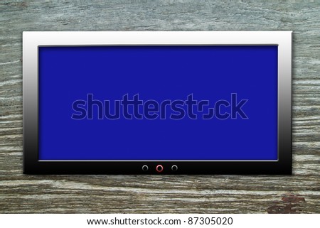 Blank display television on old wood wall