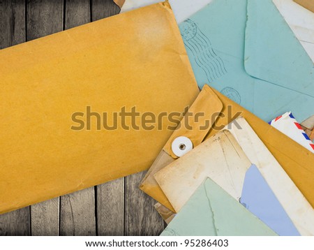 Old envelopes on wood with space for contact information or others messages