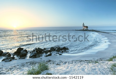 A beautiful beach and lighthouse at sunrise \
\
(Marken The Netherlands)