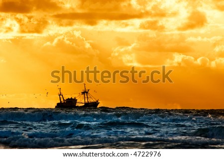 fishing ship at sea with sunset