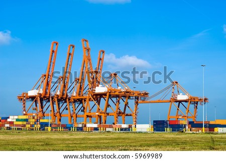 huge red cranes and containers