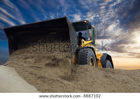 Bulldozer at work with sunset background