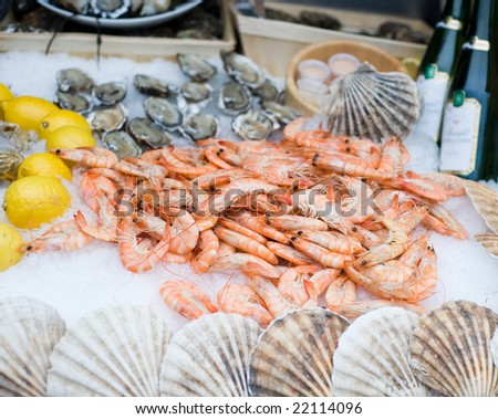 fresh shrimps on ice with lemon and oysters