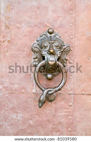 Old metal door handle on a iron plate