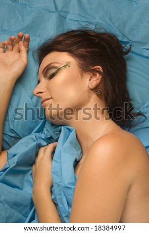 woman sleeping blue studio lighting makeup eyes closed dreams bedclothes