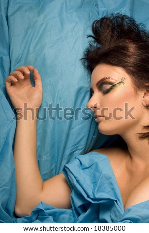 woman sleeping blue studio lighting makeup eyes closed dreams bedclothes