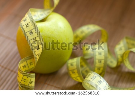 Apple and metric ribbon, symbol for diet and healthy lifestyle