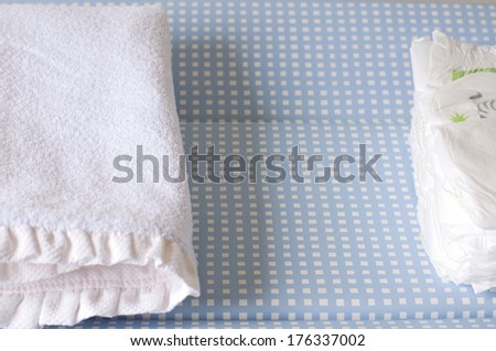 Changing table with diapers and towel for baby care