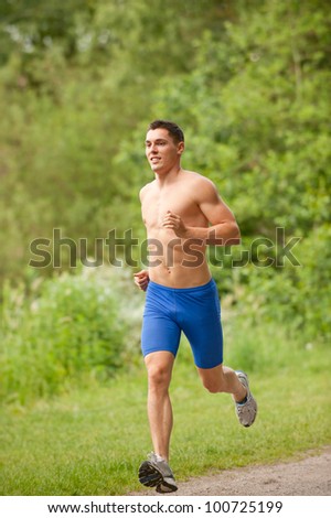 Young and smiling jogger  in the park