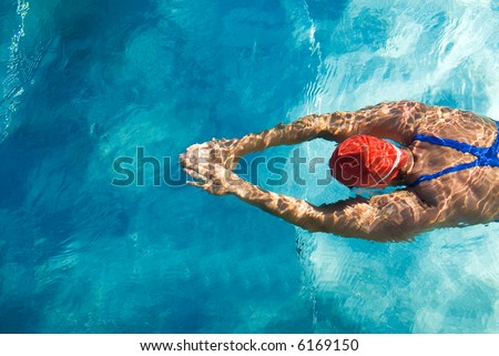 Athletic swimmer is diving in a swimming pool Athletic swimmer is diving in a swimming pool