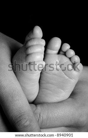 Foot from a four weeks old baby. Studio picture in black and white
