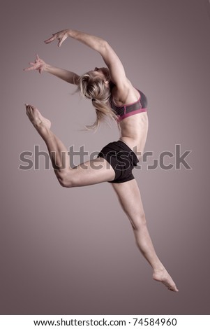 Young and beautiful woman jumping with hands in the air