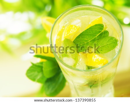 a glass  water with lemon and mint