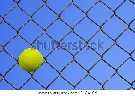 Tennis Ball in a Chain Link Fence