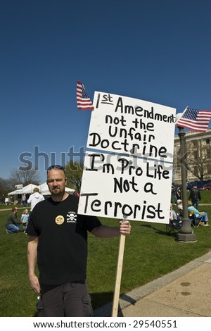 ST PAUL, MN - MAY 2:  Man holds sign stating political views at Jason Lewis Tax Cut Coalition Rally May 2, 2009 in St. Paul, MN.
