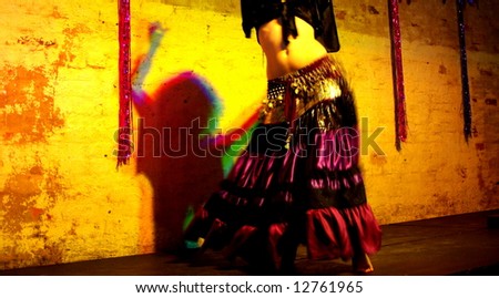 Photograph featuring the lower body of a belly dancer and the silhouette of her upper body (Adelaide, Australia).