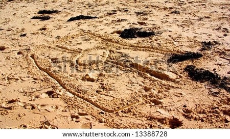 The Aboriginal flag drawn in the sand at Port Willunga (Adelaide, Australia).