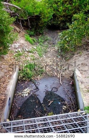 A drain at the seaside featuring nets designed to trap litter, to prevent pollution of the ocean (Semaphore, Australia).