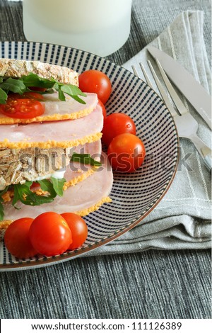 Ham, tomato, and rocket brown bread sandwich with mayonnaise