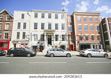 CHESTER, CHESHIRE - AUGUST 4, 2014: Shop frontages. Chester has a number of medieval buildings, but some of the black-and-white buildings within the city centre are Victorian restorations