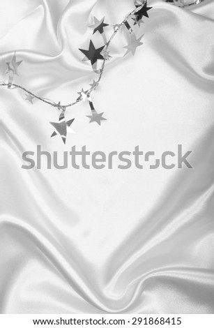 Silver stars and spangles on white silk can use as background