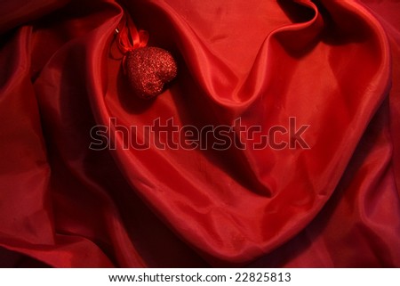 Red heart from elegant red silk for St Valentine\'s day background