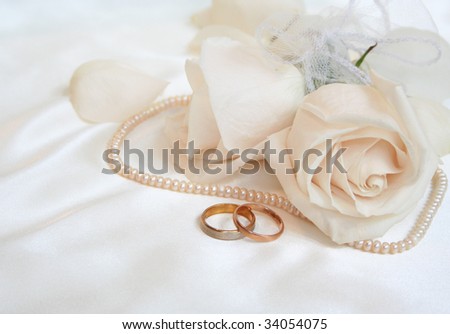 stock photo Wedding rings and roses as background