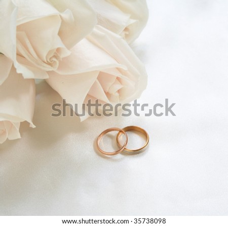 stock photo Wedding rings and roses can use as background