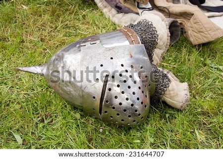 Medieval helmet fallen on the ground