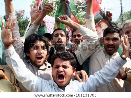 LAHORE, PAKISTAN - APR 27: Supporters of Peoples Party (PPP) shout slogans during demonstration against conviction of Prime Minister Syed Yousuf Raza Gilani, on  April 27, 2012 in Lahore.