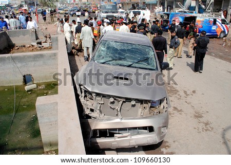 PESHAWAR, PAKISTAN - AUG 08: Security officials inspecting the blast site after a explosion occurred at Hayatabad phase-III Chowk, on August 08, 2012in Peshawar.