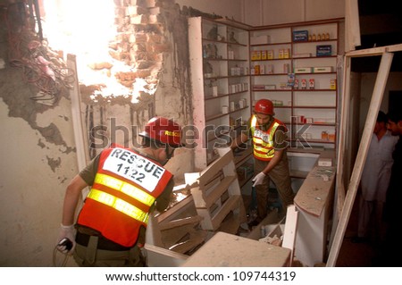 PESHAWAR, PAKISTAN - AUG 09: Security officials inspecting the blast site after a explosion occurred on Kohat Road near Sikkim Chowk. No loss of life was reported. on  August 09, 2012 in Peshawar.