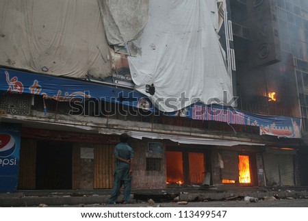 KARACHI, PAKISTAN - SEP 21: burning cinema at M.A Jinnah Road that was set a ablaze by angry protesters during protest demonstration on September 21, 2012 In Karachi.