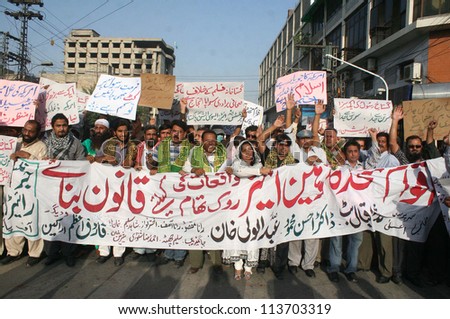 LAHORE, PAKISTAN - SEP 24: Members of Journalists and Writer Association of Pakistan are protesting against blasphemy anti-Islam movie released on Internet by USA, on September 24, 2012 in Lahore.