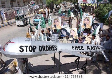HYDERABAD, PAKISTAN - OCT 05: Activists of Aafia Movement shout slogans against  Drone attacks in Pakistan and for release of Dr Aafia Siddiqui from the US prison. on October 05, 2012 in Hyderabad.