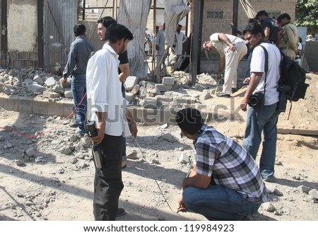 KARACHI, PAKISTAN - NOV 26: Bomb Disposal Squad (BDS) officials inspect site after  bomb blast at precast bricks depot in Malir area on November 26, 2012 in Karachi.