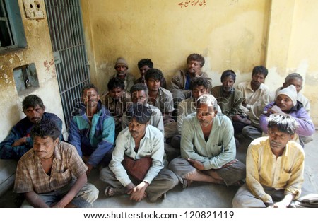 KARACHI, PAKISTAN - DEC 04: Arrested Indian fishermen sit at docks police station after their arrest, on December 04, 2012 in Karachi.