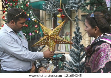KARACHI, PAKISTAN - DEC 12: A Christian family busy in decorating their home in  connection of Christmas on December 12, 2012 in Karachi.
