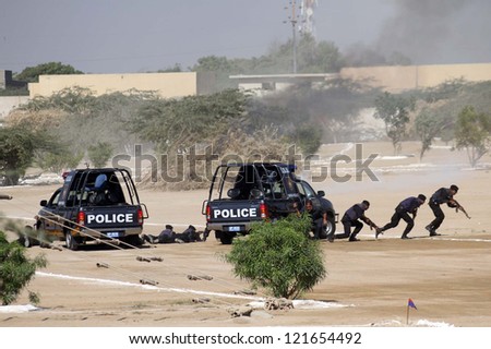 KARACHI, PAKISTAN - DEC 12: Sindh Police commandos showing their efforts during  passing out parade and training at Razzaqabad Police Training Center on  December 12, 2012 in Karachi.