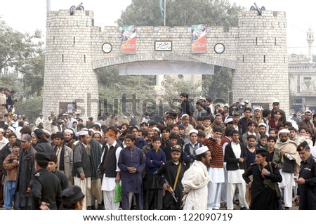 KHYBER AGENCY, PAKISTAN - DEC 17: People gather at site after car bomb blast at a  market situated at Jamrud area on December 17, 2012 in Khyber Agency.