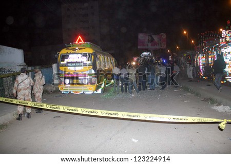 KARACHI, PAKISTAN - JAN 01: People gather at site after bomb blast, at Aisha Manzil on January 01, 2013 in Karachi. Two people were killed and at least 30 others had been injured.