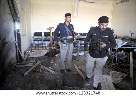 PESHAWAR, PAKISTAN - JAN 02: Police officials inspect at the site after explosion in premise of the University of Peshawar on January 02, 2013 in Peshawar. Two people sustained minor injuries.