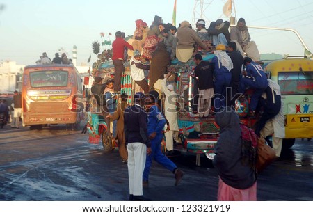 KARACHI, PAKISTAN - JAN 02: Passengers traveling on an overloaded bus as the shortage of transportation is being observed in city due to shortage of CNG  on January 02, 2013 in Karachi.