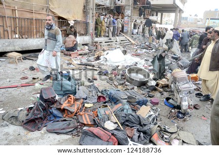 QUETTA, PAKISTAN - JAN 10: People gather at site after bomb blast at Bacha Khan Chowk  on January 10, 2013 in Quetta. At least eleven people were killed and more than 50  injured