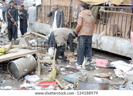 QUETTA, PAKISTAN - JAN 10: People gather at site after bomb blast at Bacha Khan Chowk  on January 10, 2013 in Quetta. At least eleven people were killed and more than 50 injured