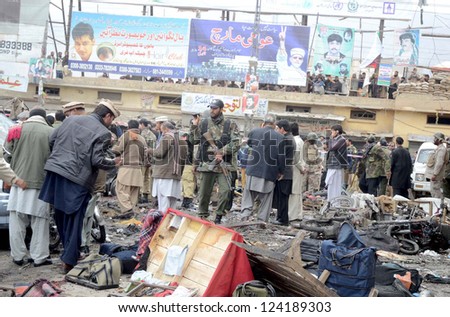 QUETTA, PAKISTAN - JAN 10: People gather at site after bomb blast at Bacha Khan Chowk in Quetta on Thursday, January 10, 2013. At least eleven people were killed and more than 50 injured.