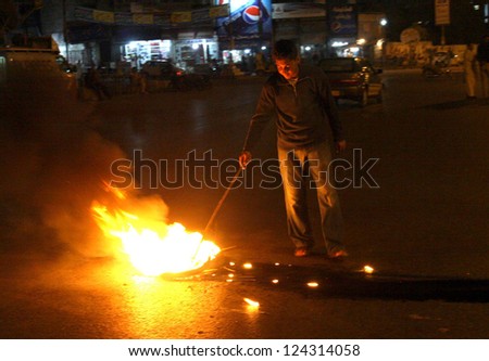 KARACHI, PAKISTAN - JAN 11: Angry Shiite Muslims protesters burn tyres on road during protest demonstration against Qandhari Imambargah Alamdar Road blasts IN Quetta on  January 11, 2013 in Karachi.