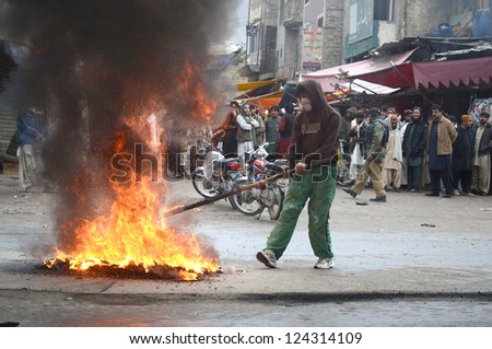 QUETTA, PAKISTAN - JAN 11: Shiite Muslims protesters burn tyres on road during  protest demonstration against Qandhari Imambargah Alamdar Road blasts at Bacha Khan Chowk on January 11, 2013 in Quetta.