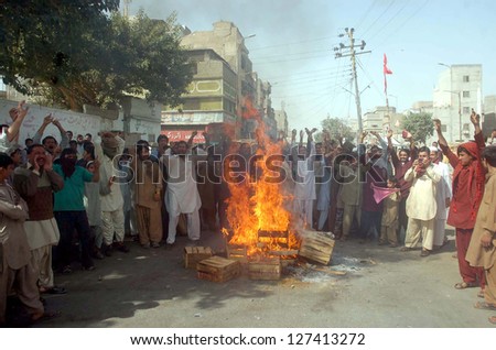KARACHI, PAKISTAN - FEB 07: Residents of Old Sabzi Mandi burn fire and blocked the road as they are protesting against non availability of water and load shedding on February 07, 2013 in Karachi.