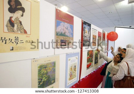 PESHAWAR, PAKISTAN - FEB 07: Visitors take keen interest in calendars during Japanese Calendar Exhibition held at Gandhara University on February 07, 2013 in Peshawar.